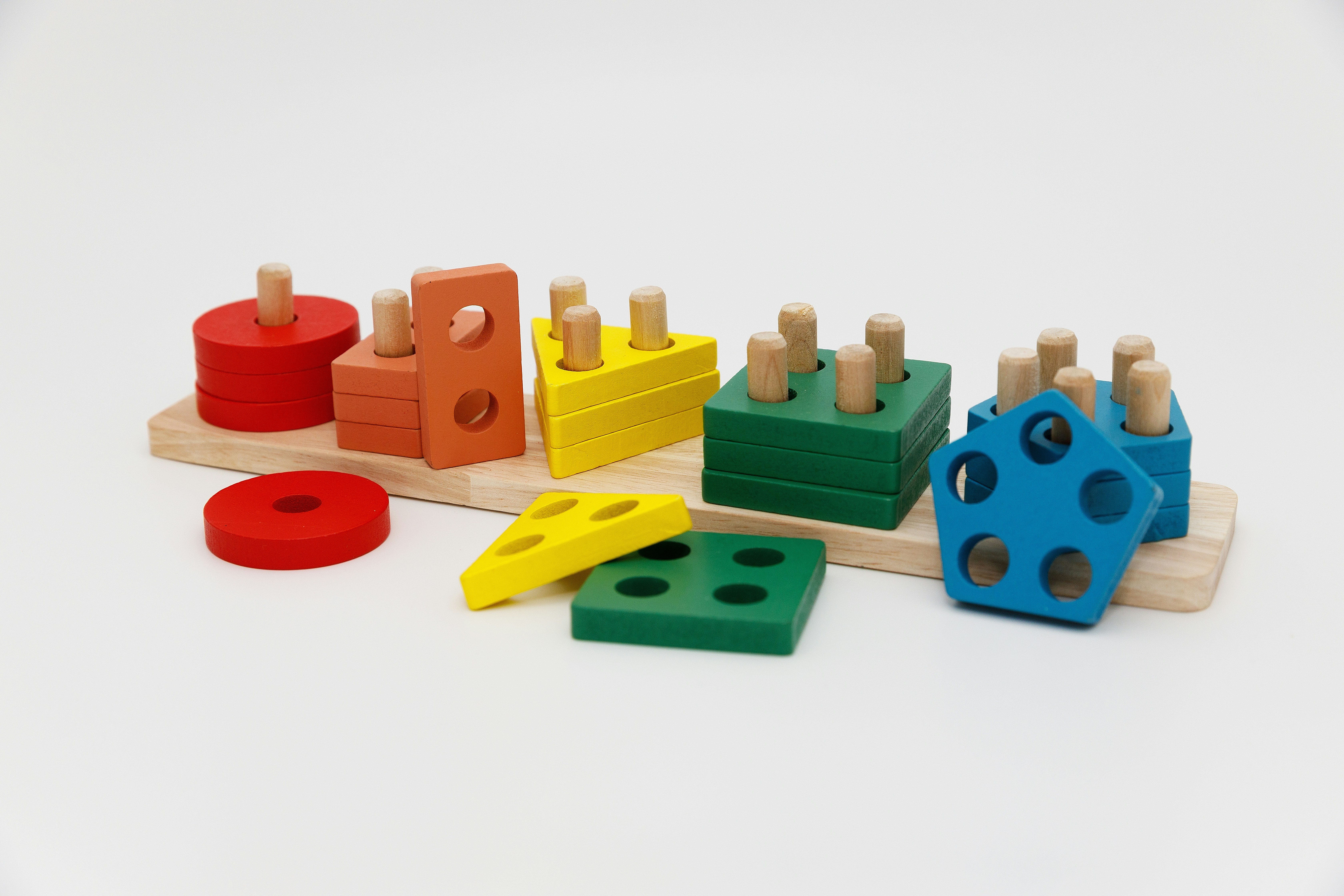 Image of wooden toy shapes sorted into correct columns