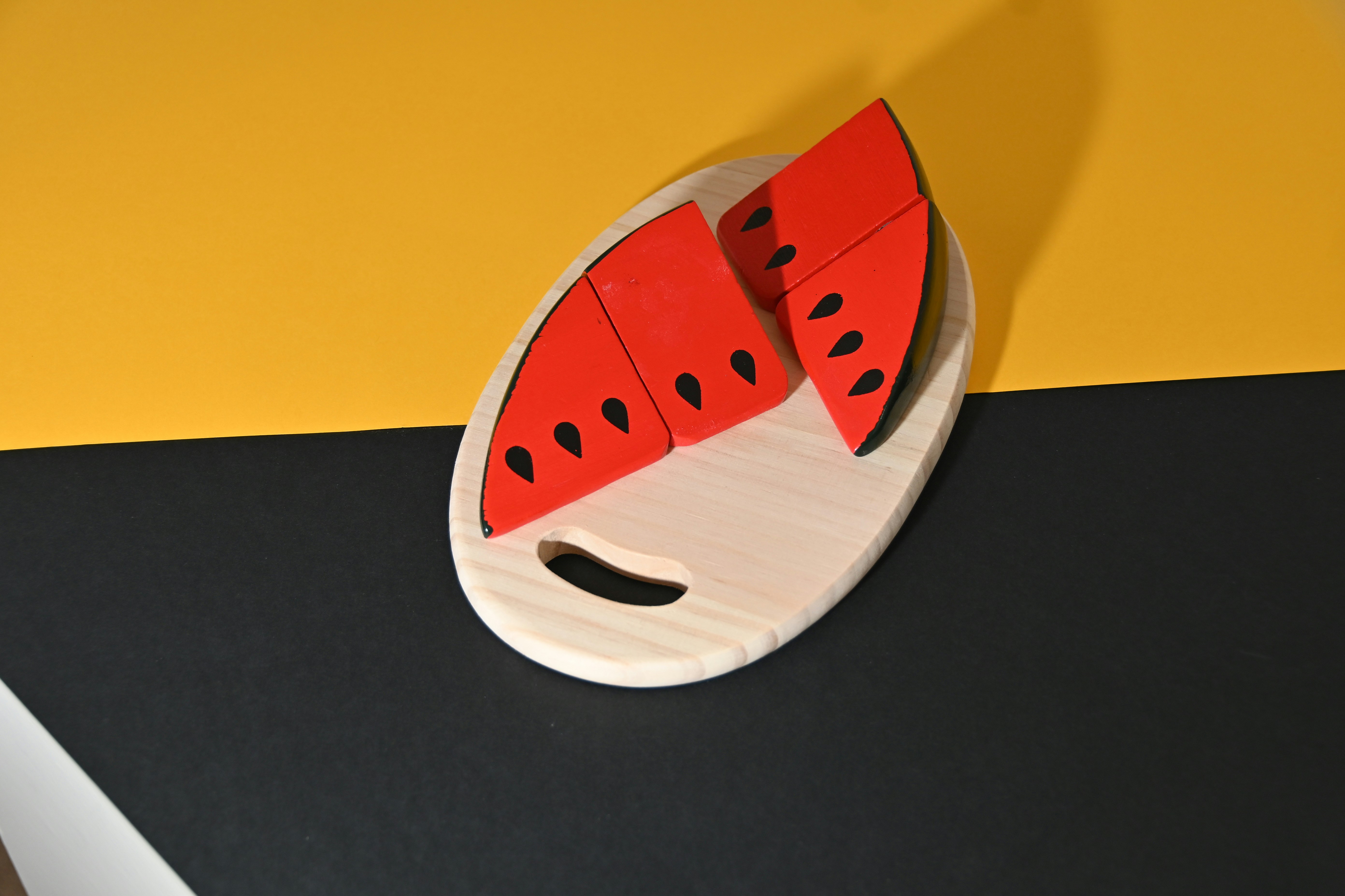 Image of wooden watermelon on a wooden chopping board