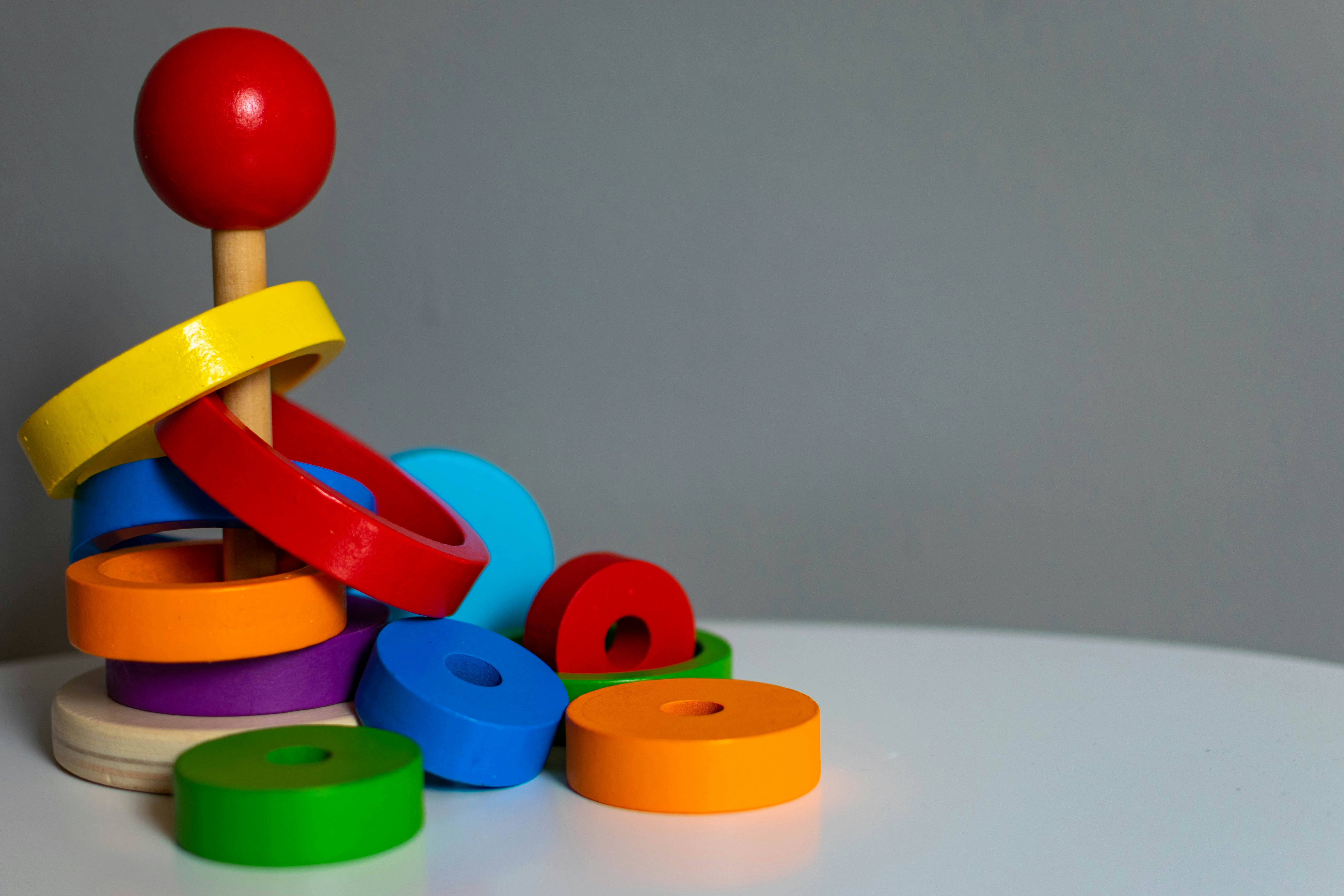 Wooden toy sequencing game where the player has to stack largest to smallest circles in order